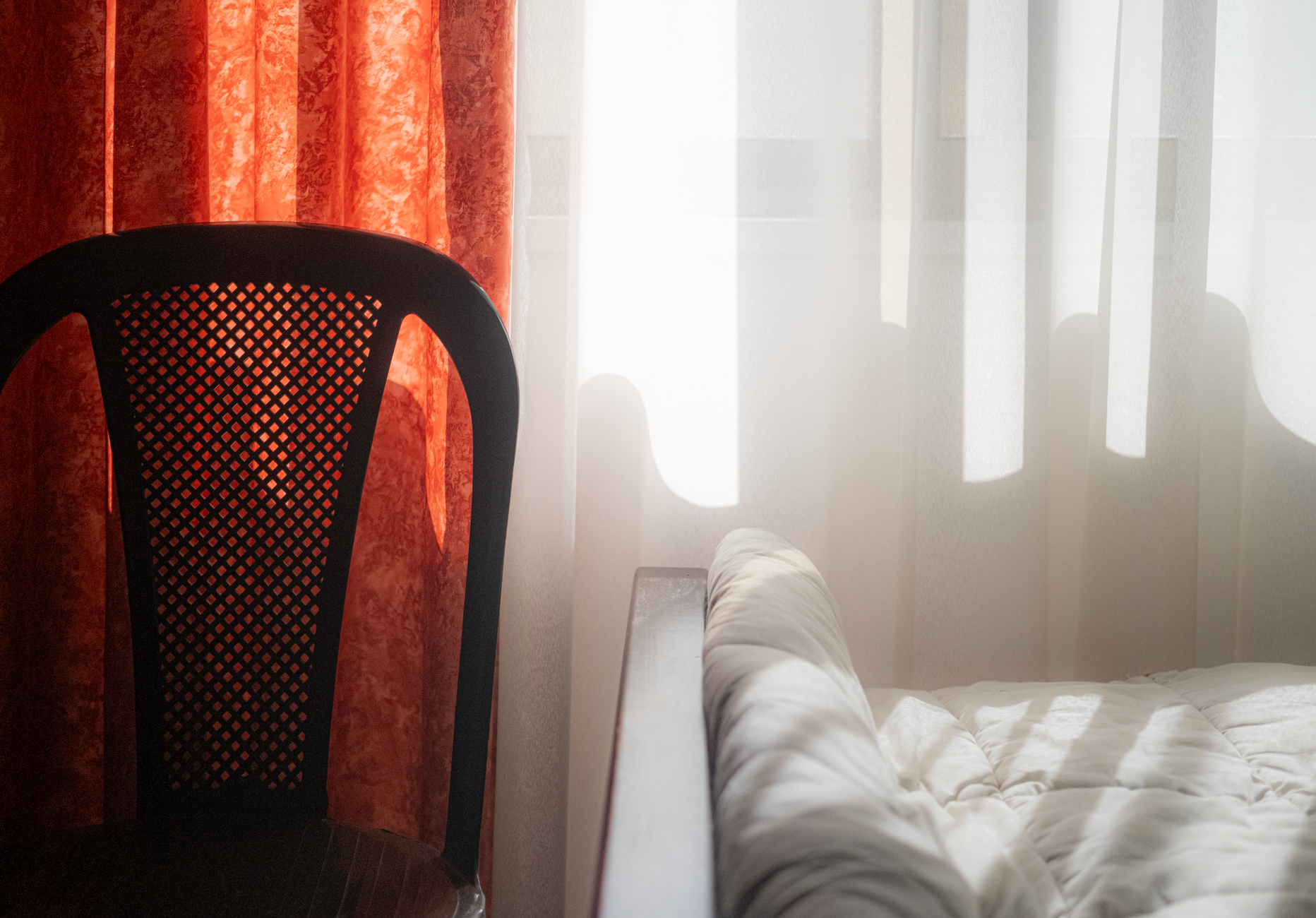 Bedroom interior showing clean textile surfaces and organized space after deep-cleaning protocol